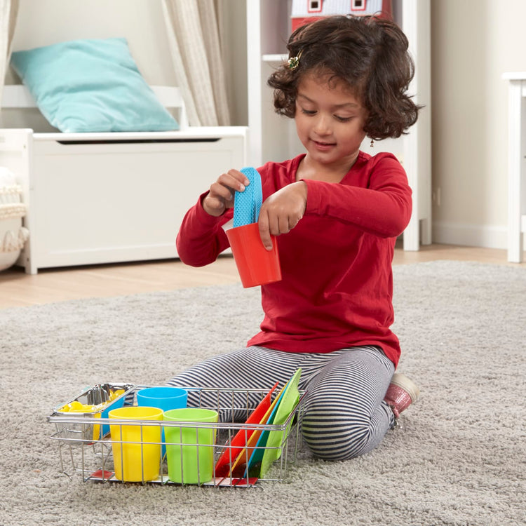 A kid playing with the Melissa & Doug Wash and Dry Dish Set - 24 Pieces