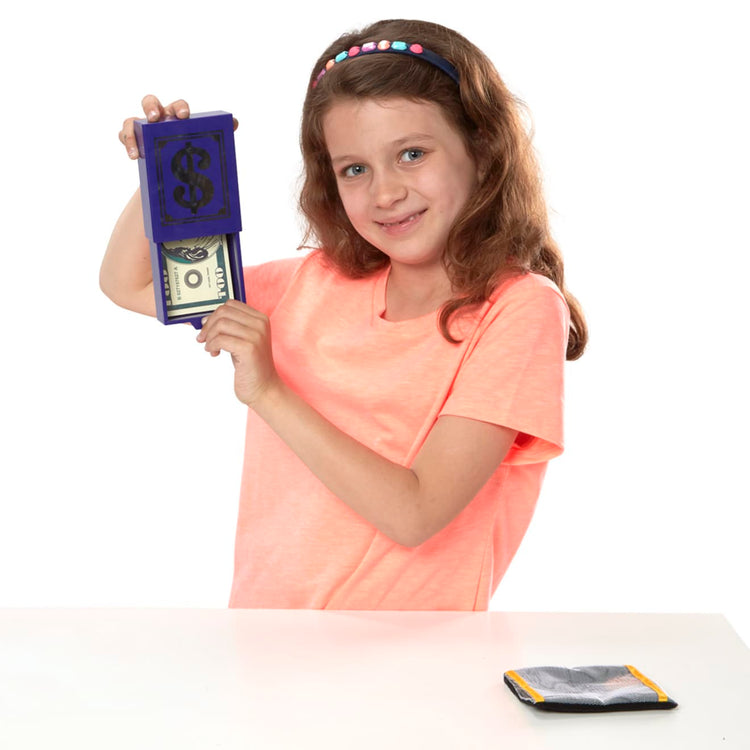 A child on white background with the Melissa & Doug Magic in a Snap! Hocus Pocus Collection Magic Tricks Set (12 pcs)