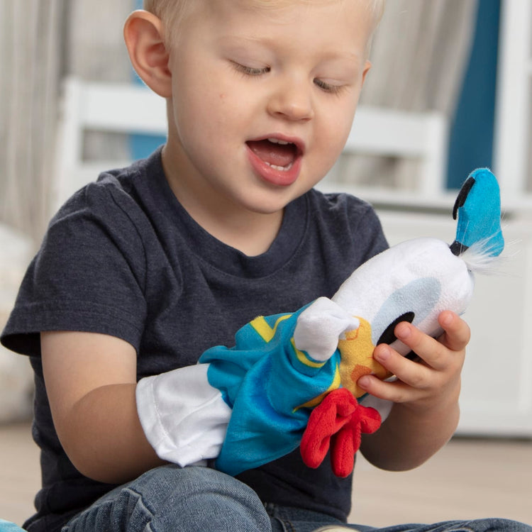 A kid playing with the Mickey Mouse & Friends Soft & Cuddly Hand Puppets