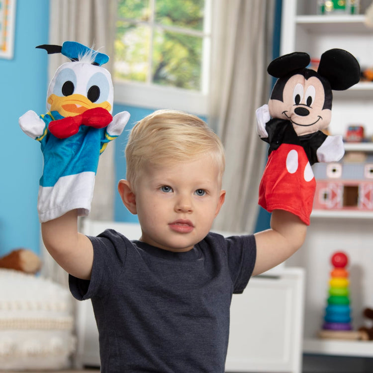 A kid playing with the Mickey Mouse & Friends Soft & Cuddly Hand Puppets