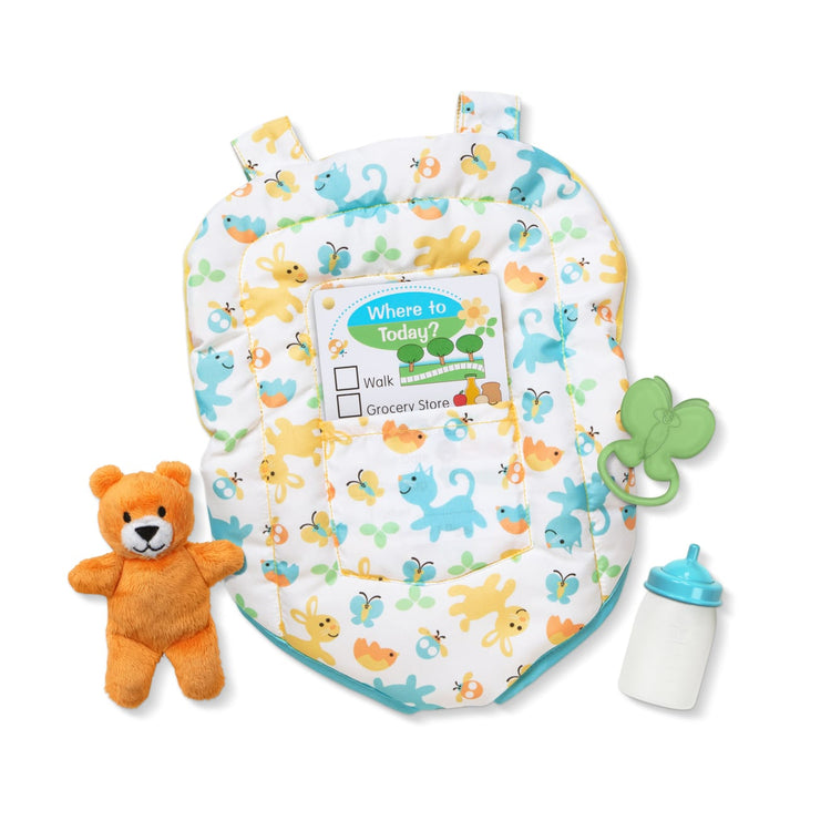 The loose pieces of the Melissa & Doug Mine to Love Carrier Play Set for Baby Dolls with Toy Bear, Bottle, Rattle, Activity Card