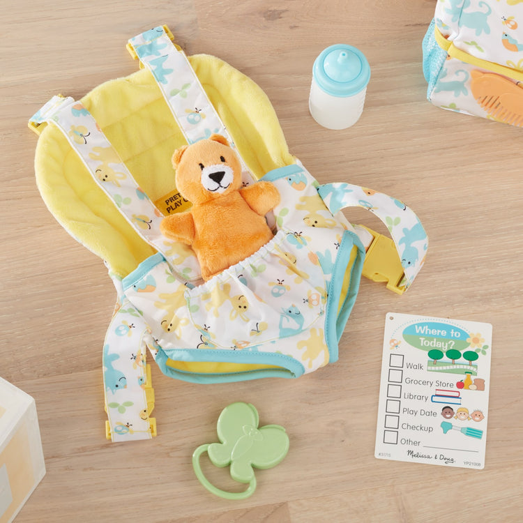 the Melissa & Doug Mine to Love Carrier Play Set for Baby Dolls with Toy Bear, Bottle, Rattle, Activity Card