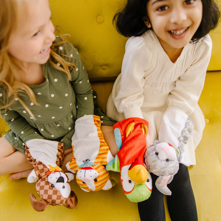 A kid playing with the Melissa & Doug Playful Pets Hand Puppets (Set of 4)