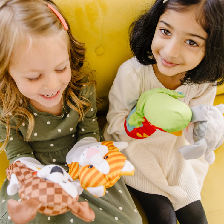 A kid playing with the Melissa & Doug Playful Pets Hand Puppets (Set of 4)