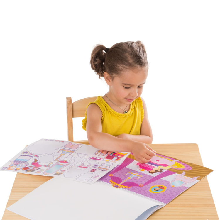 A child on white background with the Melissa & Doug Reusable Sticker Pads Set: Fairies, Princess Castle, Play House, Dress-Up - 680+ Stickers