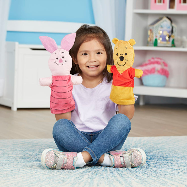 A kid playing with the Winnie the Pooh Soft & Cuddly Hand Puppets